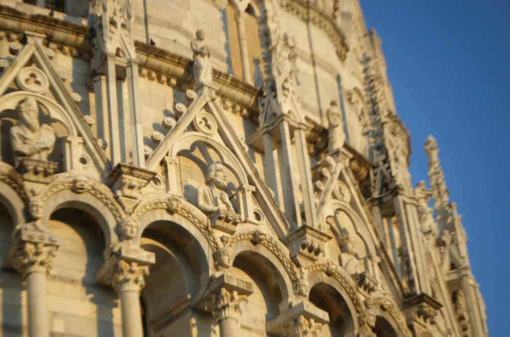 Intricately carved stone facade with a several male busts carved.