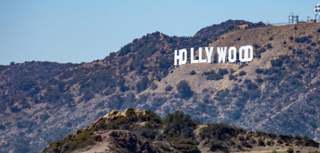 The Hollywood sign on a sunny day, taken from a distance.